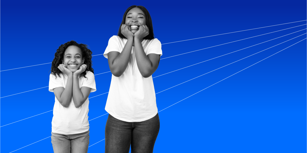 mother and daughter wearing matching white shirts smiling with their hands under their chins