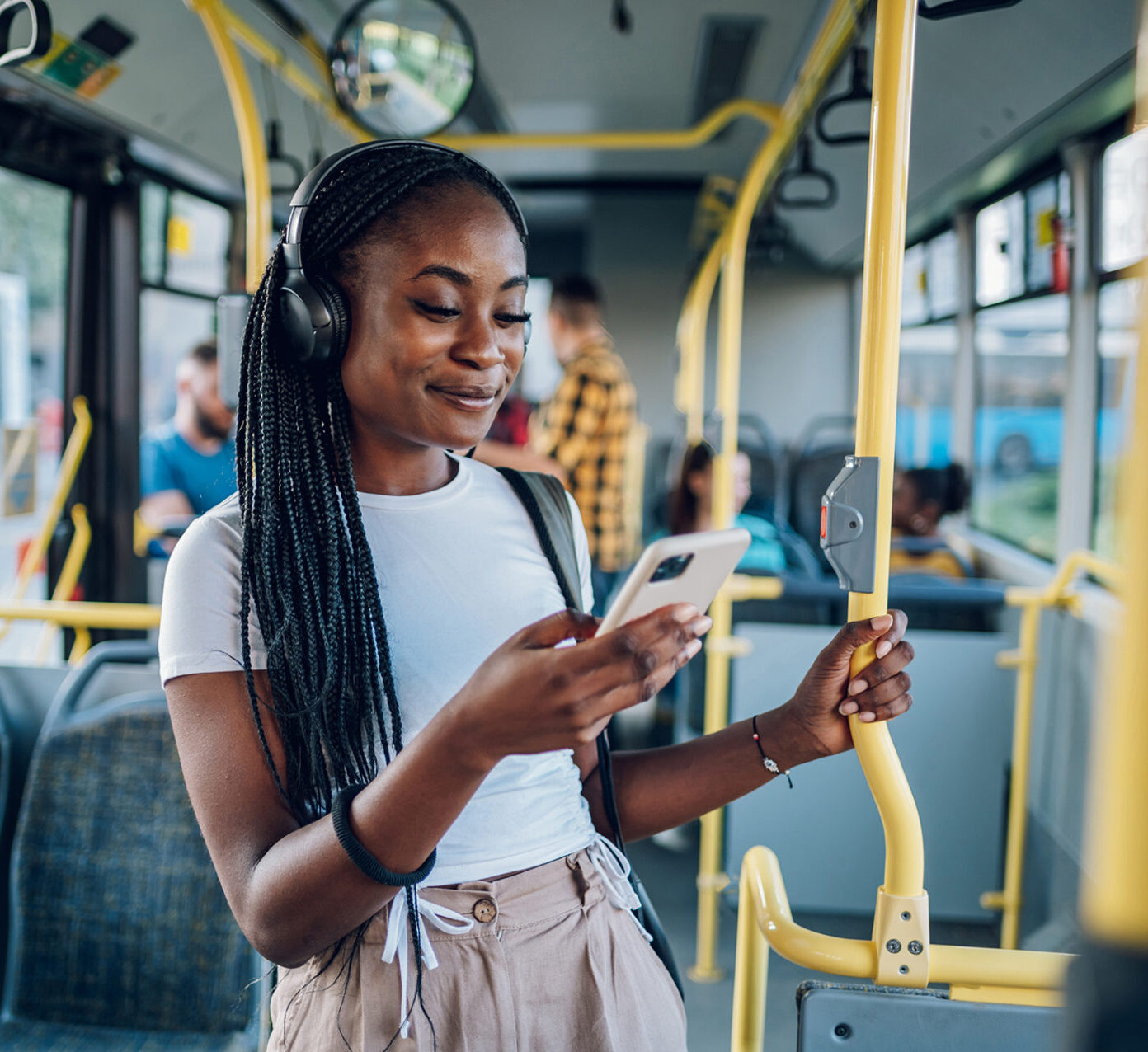 African American Woman Using Smartphone While Riding A Bus